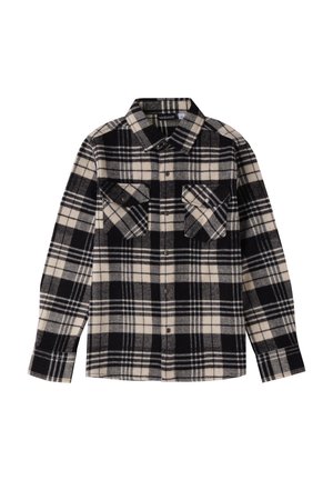 Camicia flanella a quadri in bianco e nero con due tasche sul petto, chiusura frontale con bottoni e colletto a punta; texture morbida e maniche lunghe.