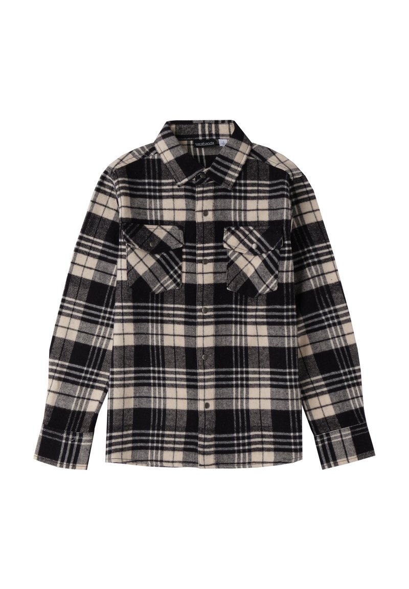 Camicia flanella a quadri in bianco e nero con due tasche sul petto, chiusura frontale con bottoni e colletto a punta; texture morbida e maniche lunghe.