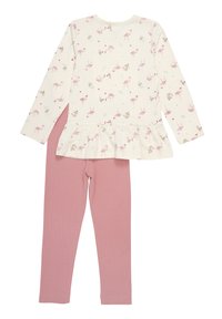 Long-sleeve top with cream base, pink flamingo print, and ruffled hem, paired with solid pink leggings. Soft cotton fabric throughout.
