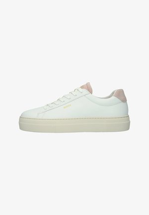 White leather sneaker with a pale pink suede heel accent. Features flat laces, a textured rubber sole, and a minimalist design.