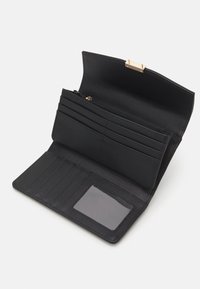 Black wallet with a structured design, featuring multiple card slots, a zippered pocket, and a clear ID window. Textured material. Gold hardware.