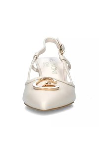 Scarpa piatta slingback in pelle beige con punta a mandorla, caratterizzata da un'accenno in metallo dorato a forma di logo. Design minimalista.