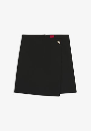 Black wrap skirt with a smooth texture, featuring a red logo tag and a silver hardware accent. Simple design with a clean cut.