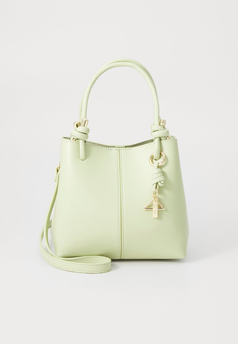 Šviesiai žalia rankinė, pagaminta iš lygios sintetinės medžiagos. Pasižymi auksinės spalvos detalėmis, pintu rankenėle ir nuimamu kryžminiu diržu.