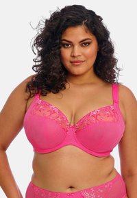 Růžové krajkové podprsenky s květinovou výšivkou, síťovanými panely a nastavovacími ramínky. Texturovaná tkanina s poloprůhledným povrchem.