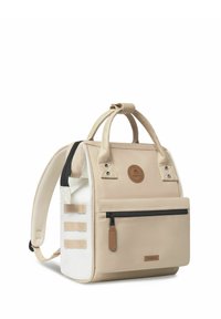 Beige rugzak van gebreid materiaal, met dubbele bovenhandvatten, verstelbare schouderbanden, een voorvak met rits en leren accenten. Met een ronde logo patch.