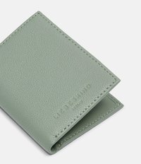 Skórzany portfel w zielonym kolorze o fakturze, ze złożoną konstrukcją. Posiada przeszywane krawędzie oraz wytłoczoną nazwę marki w dolnym rogu.