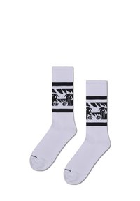 Bílé ponožky s černým grafickým vzorem s očima a palmami, kontrastními pruhy nahoře a měkkou strukturou.