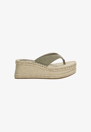 Sandales compensées en espadrilles avec une semelle en corde beige, des lanières en toile vert olive et un dessus en tissu texturé. Design léger avec un style à enfiler.
