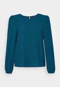 Blusa lunga teal a maniche lunghe con scollatura tonda, tessuto strutturato e spalle a palloncino. Include una chiusura a chiave sul retro.