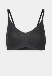 Black bralette made of textured fabric, featuring thin adjustable straps and a seamless design with a subtle wave pattern.