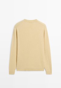 Beige long-sleeve sweater, made of soft fabric, featuring a round neck and ribbed cuffs, with a plain back design.