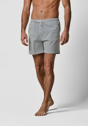 Herrebadetrusser i et blå- og hvidternet mønster, med elastisk talje og snøre samt sidelommer. Letvægtsstof.