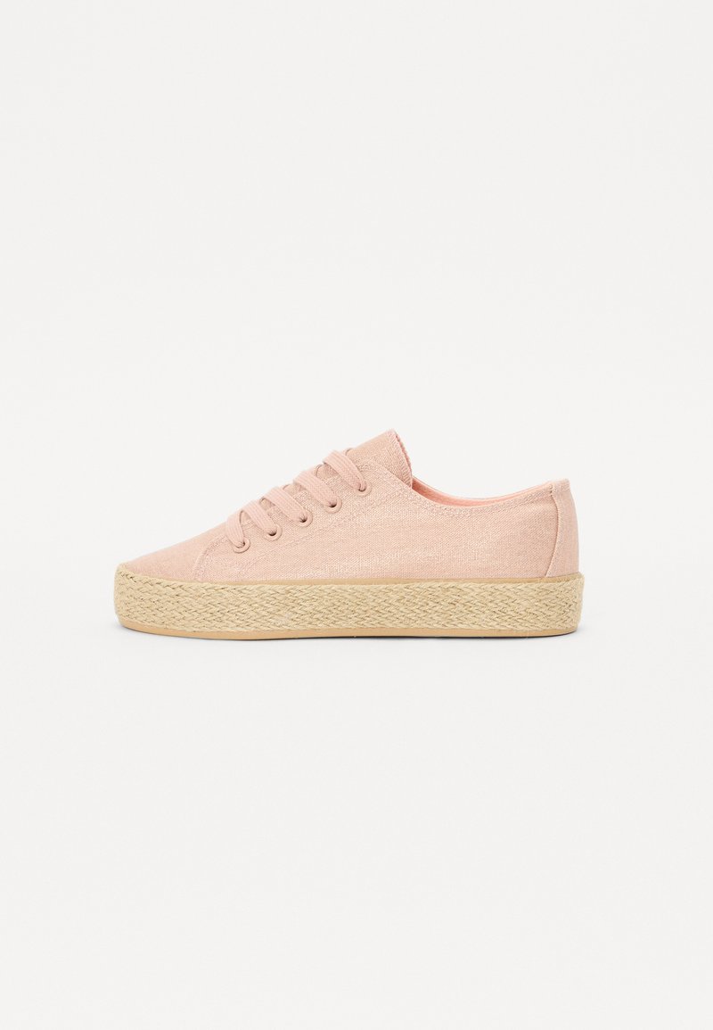 Pink canvas sneakers with round toe, lace-up front, and woven jute midsole. Smooth texture and low-cut design.