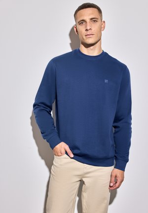 Marineblaues Rundhals-Sweatshirt aus weichem Material, mit gerippten Bündchen und Saum, kleinem Logo auf der Brust und lockerem Schnitt.