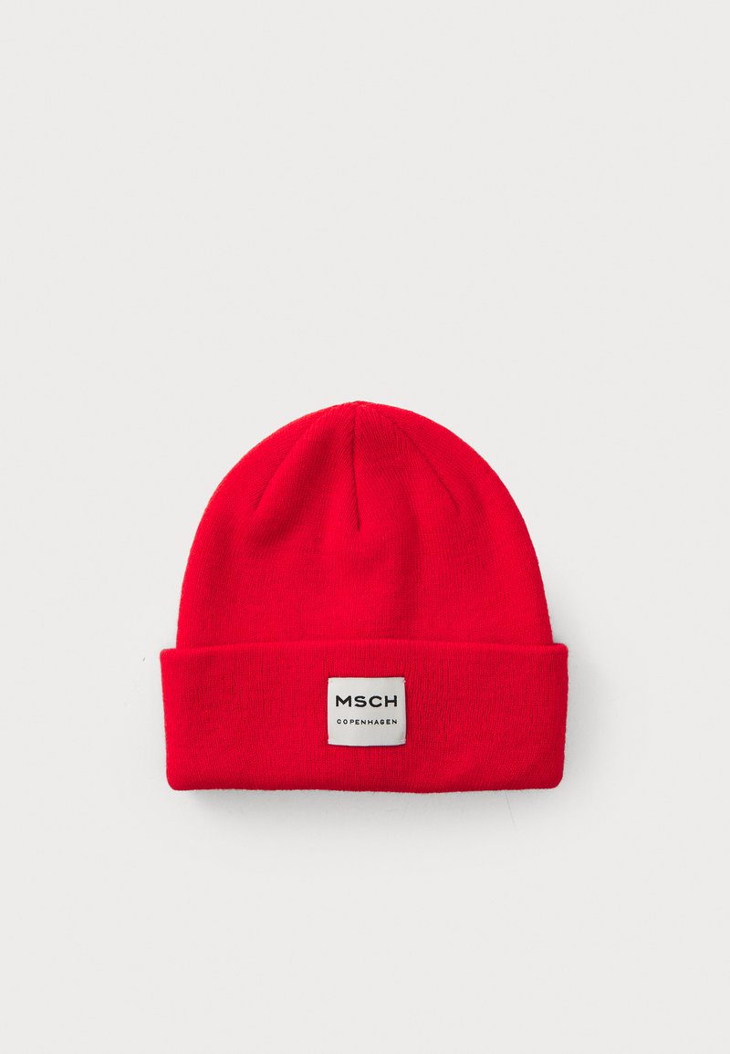 Red knitted beanie with a folded cuff, featuring a square brand tag labeled "MSCH COPENHAGEN" in black text on a white background.