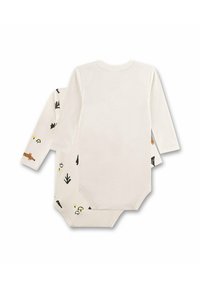 Langarm baby rompertje van off-white katoen. De ene kant heeft speelse patronen met een bos-thema; de andere kant is effen. Drukknoopsluiting aan de onderkant.