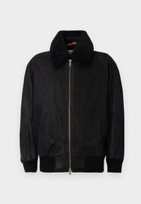 Black leather jacket with a zip front, featuring a plush collar and ribbed cuffs. Smooth texture with minimal detailing and side pockets.