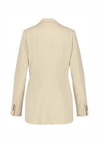 Beige tailored blazer with a single collar, straight cut, and long sleeves. Features buttoned cuffs and a minimalist design.