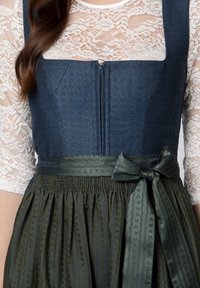 Dark blue bodice with textured diamond pattern, white lace sleeves, and green pleated skirt featuring a tied bow at the waist.