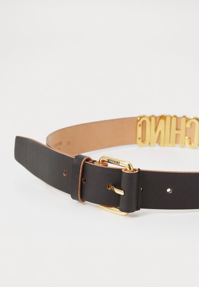 Black leather belt with gold buckle and gold "MOSCHINO" lettering detail, shown coiled on a plain white background.