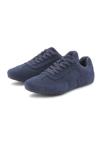 Navy blue suede sneakers with a low profile, featuring a textured upper, rounded toe, and rubber sole with grip for traction.