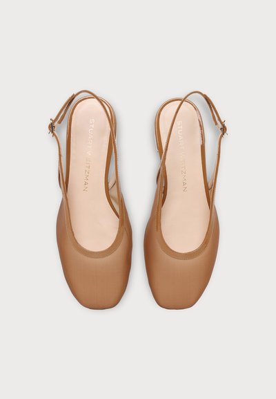 Pair of tan slingback flats with square toe and adjustable buckle straps, featuring Stuart Weitzman branding on the insoles.