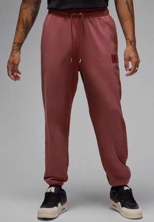 Murmørke sweatpants med taperet pasform, elastisk talje og justerbar snor. Har et lille logo-patch og ribbede cuffs.