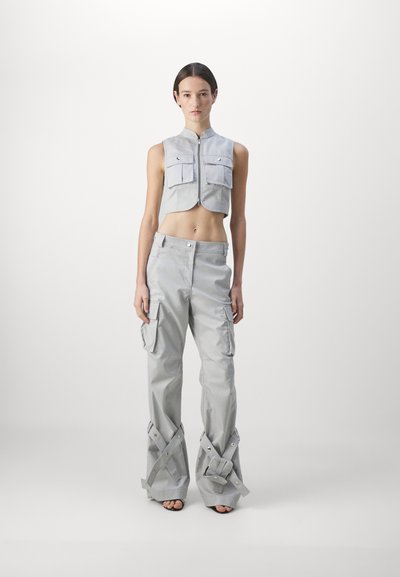 Gray cropped vest with two patch pockets and a front zipper paired with wide-leg cargo pants featuring side pockets and crisscross detail at the hem.