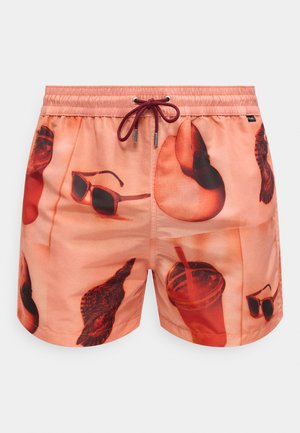 Men’s coral swim shorts with drawstring waist and printed images of sunglasses, drink cup with straw, and various birds.