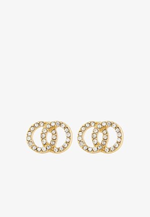 Auksinės spalvos auskarai, kuriuose yra trys tarpusavyje sujungtos kilpos, puoštos skaidriais kristalais, turinčios lygią, blizgią paviršių.