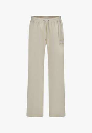 Pantalons de survêtement beige en tissu doux, dotés d'une taille élastique avec cordon de serrage, de poches latérales et d'un simple logo sur la jambe gauche.