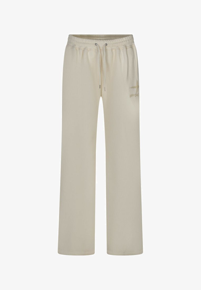 Pantalons de survêtement beige en tissu doux, dotés d'une taille élastique avec cordon de serrage, de poches latérales et d'un simple logo sur la jambe gauche.