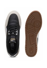 Black leather sneakers with gray and white accents, featuring a textured finish, black laces, and a brown rubber outsole with a geometric pattern.
