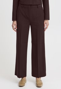 Brown wide-leg trousers made from a smooth fabric, featuring a belt, pleats, and a tailored fit. Suitable for formal or casual wear.