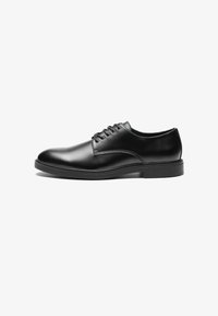Black leather dress shoe with a smooth finish, rounded toe, six eyelet lace-up design, and a flat rubber sole.