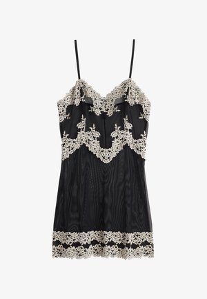 Zwarte kanten camisole met een bloemenkant afwerking bij de halslijn en zoom, met dunne verstelbare bandjes. Doorzichtig materiaal met een gestructureerd patroon.