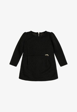 Robe noire à manches longues avec des pois dorés, décolleté rond et fermeture éclair au dos. Dispose d'une petite poche latérale et d'une texture lisse.