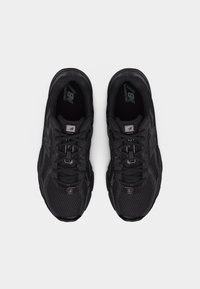 Pair of black New Balance running shoes with mesh and synthetic upper, viewed from above, laced and aligned side by side on white background.