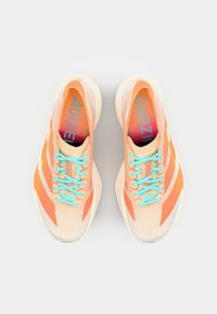 Athletic shoes with a light peach and orange design, featuring turquoise laces and “ADIZERO” branding on the insoles, viewed from above.