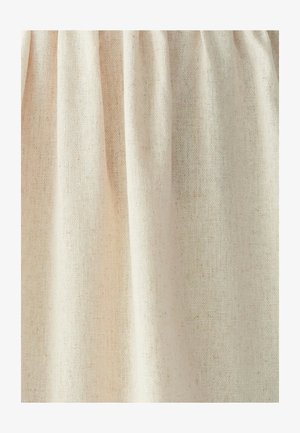 Beige loosely woven fabric with visible threads and soft folds creating vertical shadows and texture.
