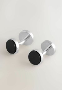 Silver-tone cufflinks with round black accents, featuring a polished finish and a sleek, minimalist design.