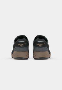 Black and gray athletic shoes with a textured upper, rounded heel, and brown accents. Features a sleek design and perforated detailing.