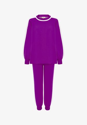 Purple knitted loungewear set featuring a long sleeve top with white accents and matching tapered pants. Ribbed cuffs at sleeves and ankles.