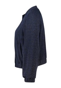 Veste bomber bleu marine en tissu texturé, avec des poignets côtelés et un col arrondi. Le matériau comporte des fils métalliques subtils pour un effet scintillant.