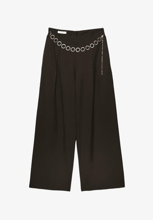 Black wide-leg pants with pleats and a decorative silver chain belt featuring circular links and a dangling strand.