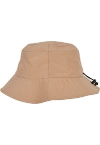 Beige bøttehatt laget av stoff med rund krone, bred brem og snor for justerbar passform; har synlige sømmer.