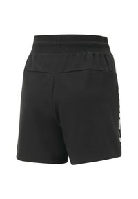 Shorts de sport noirs en tissu doux, avec une taille élastique et un texte graphique blanc sur le côté. Disponible en coupe décontractée.