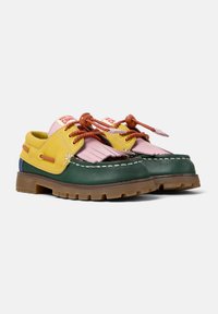 Multicolored boat shoes featuring yellow, pink, and green leather. They have a moccasin-style design, fringed accents, and brown laces.