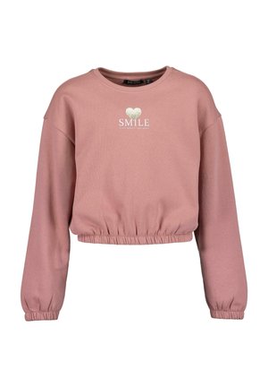 Roze cropped sweatshirt van zacht materiaal. Heeft lange mouwen, een elastische rand en zilveren tekst "SMILE" met daarboven een hart.